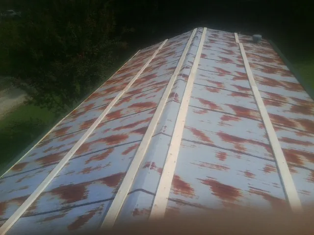 Rusted metal roof panels with new wood purlins before replacement — Storm Damage Roof Repair in West Wareham by Roofing Brothers